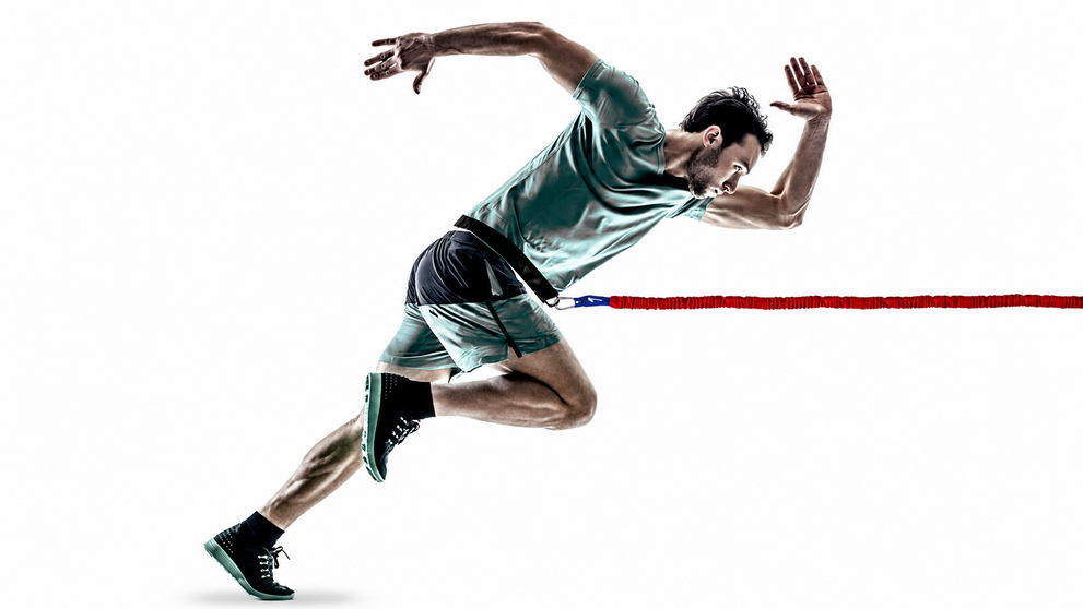 Athlete performing overspeed training with resistance.