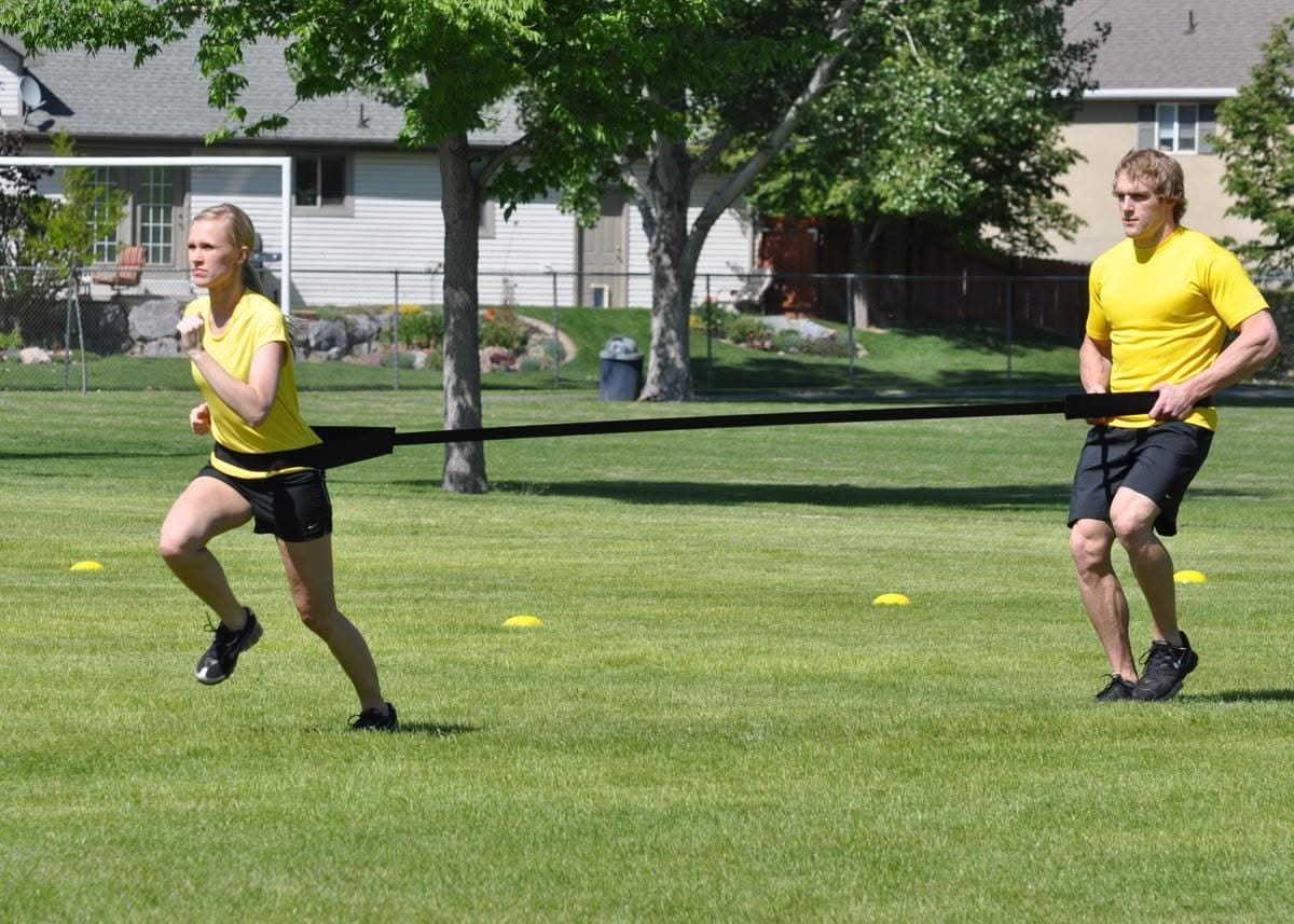 Dual Resistance Trainer-one strap to train 2 Athletes2 athletes at the same time. One athlete pulls and the other is pulled training both speed and overspeed at the same time. Unmatched for speed training 